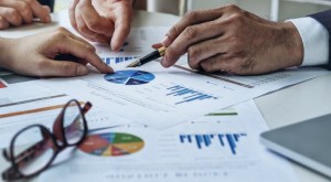 A financial advisor reviewing the performance of safe investments for a retiree.